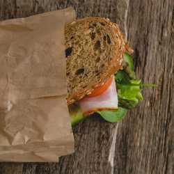 Sandwich in Brown Paper Bag on Table Sandwich in Brown Paper Bag on Table